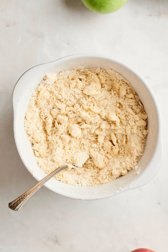 Bowl of flour and butter mixture being combined.